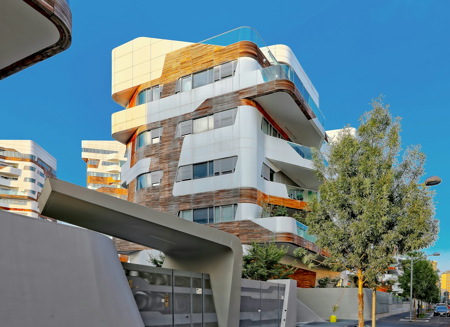 Modern apartment buildings with white and wood facades.